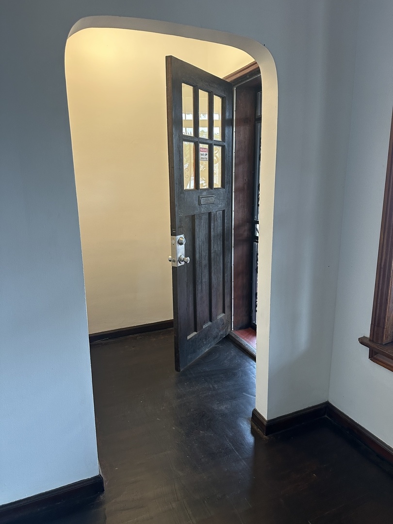 8634 South Carpenter Street Chicago, IL 60620 - Photo 3 of 28 a view of a room with wooden floor and a small window