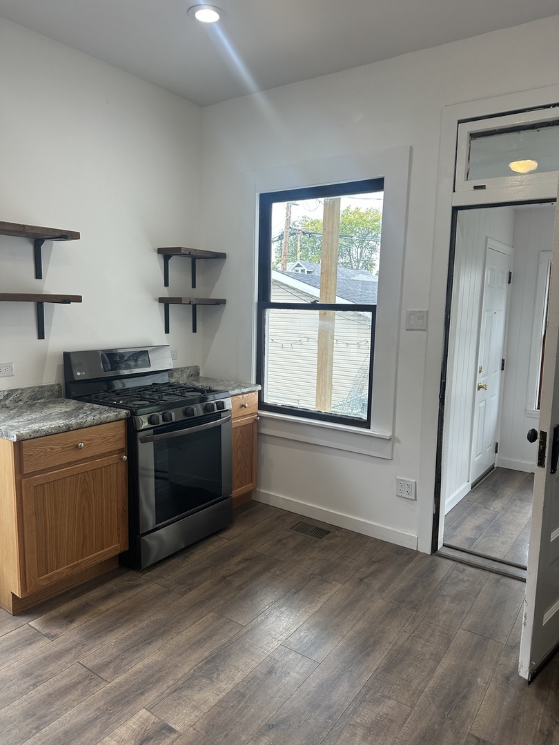 8634 South Carpenter Street Chicago, IL 60620 - Photo 8 of 28 a kitchen with stainless steel appliances granite countertop a stove and a refrigerator