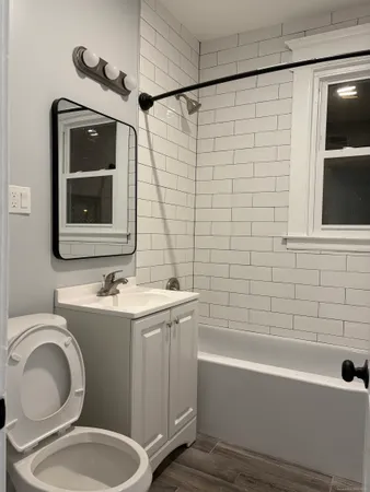 a bathroom with a toilet sink and mirror