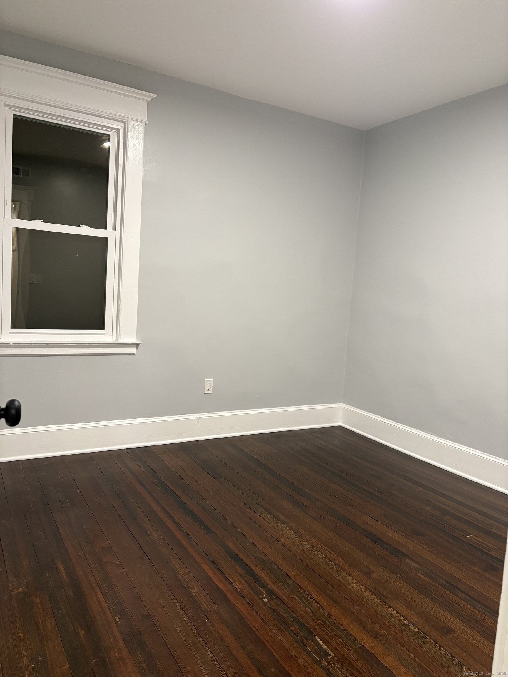72 4th Street, Unit 1 New Haven, CT 06519 - Photo 13 of 16 a view of an empty room with wooden floor and a window