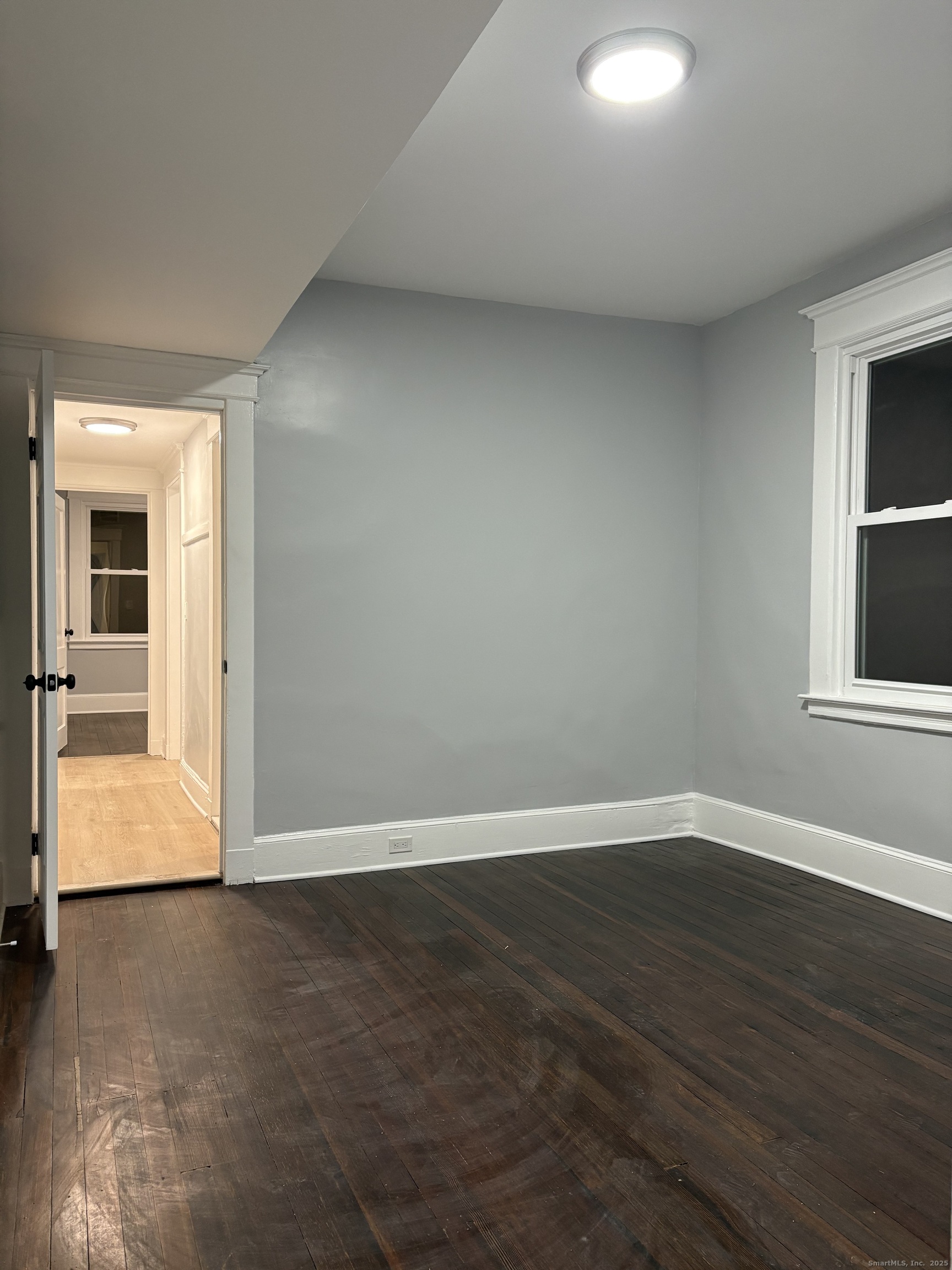 72 4th Street, Unit 1 New Haven, CT 06519 - Photo 14 of 16 an empty room with wooden floor and windows