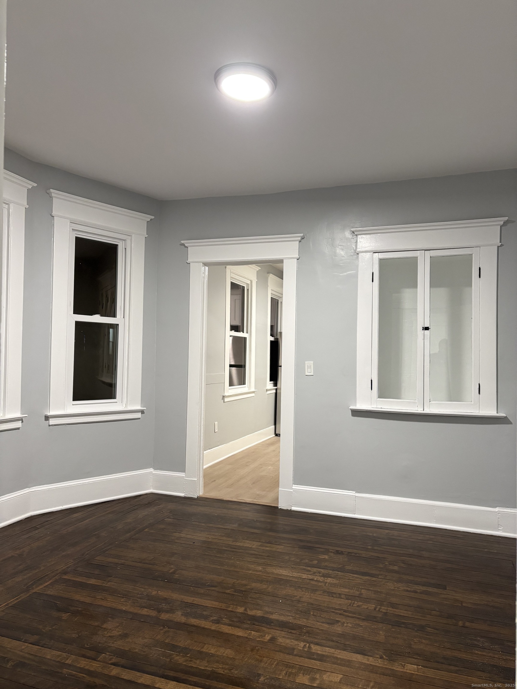 72 4th Street, Unit 1 New Haven, CT 06519 - Photo 15 of 16 a view of an empty room with wooden floor and a window