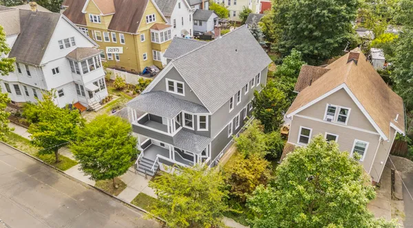 an aerial view of a house with a yard and potted plants
