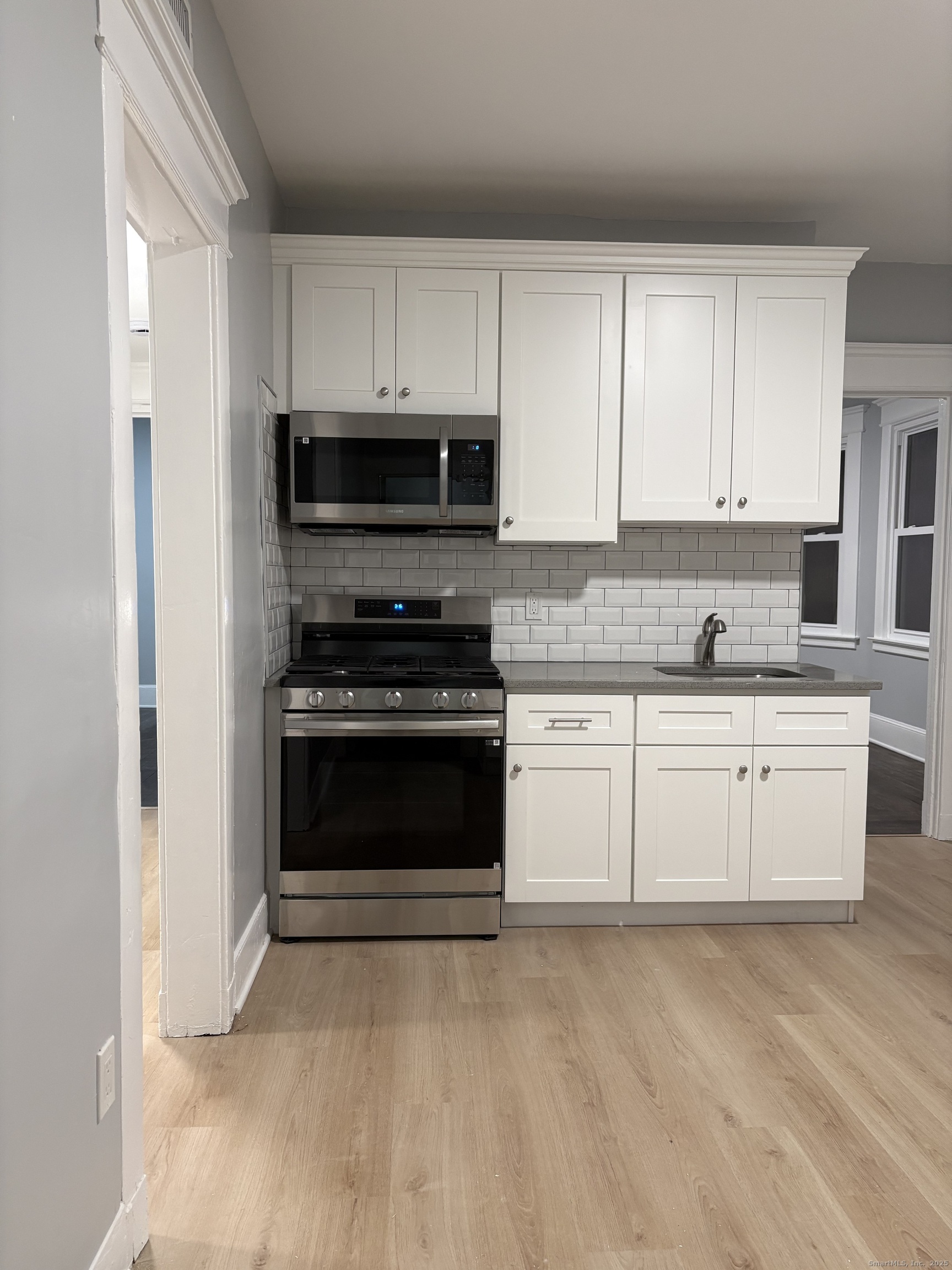 72 4th Street, Unit 1 New Haven, CT 06519 - Photo 8 of 16 a kitchen with granite countertop white cabinets and stainless steel appliances