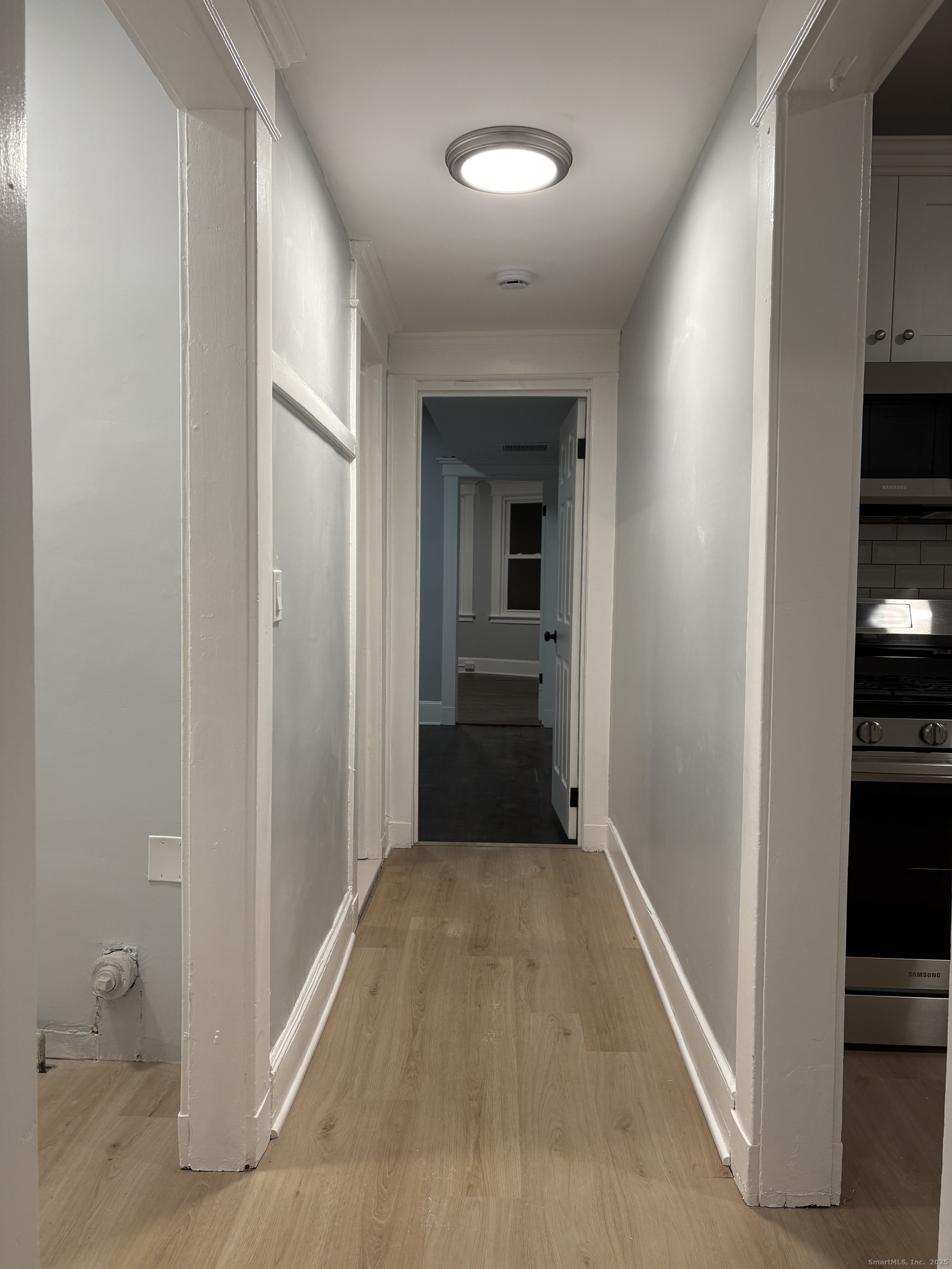 72 4th Street, Unit 1 New Haven, CT 06519 - Photo 10 of 16 a view of a hallway with wooden floor and closet
