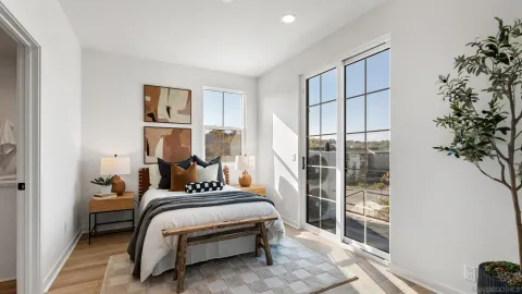 a bedroom with a bed and a potted plant
