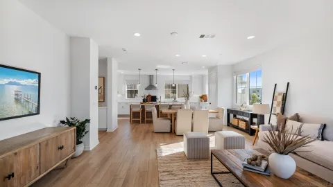 a living room with lots of furniture and wooden floor