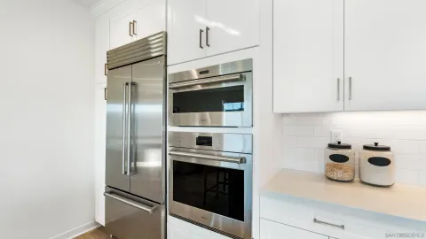 a kitchen with stainless steel appliances a stove and a refrigerator