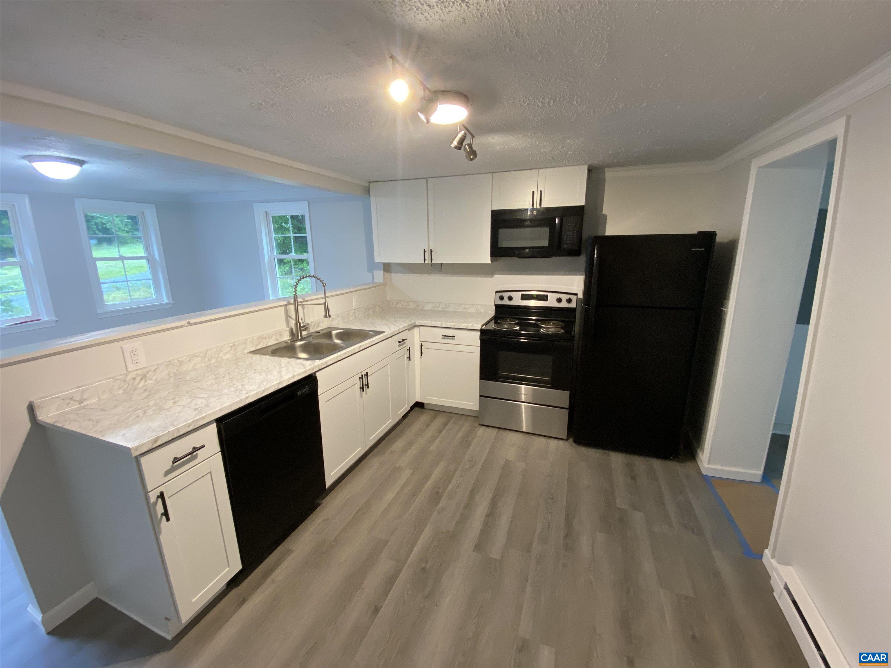 193 Rock Road New Canton, VA 23123 - Photo 2 of 12 a kitchen with stainless steel appliances kitchen island granite countertop a refrigerator a sink a stove top oven a counter space and cabinets