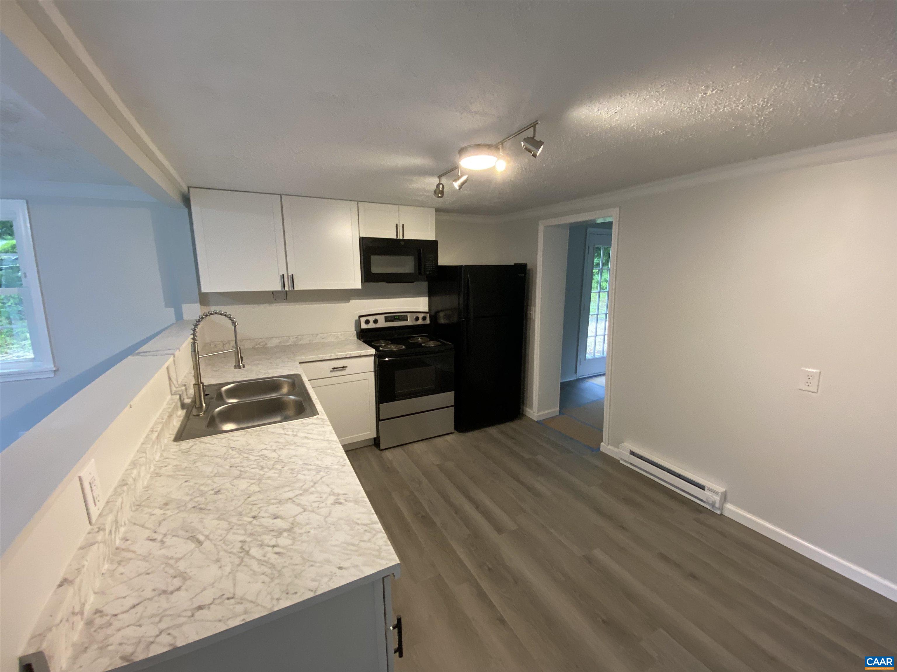 193 Rock Road New Canton, VA 23123 - Photo 3 of 12 a kitchen with granite countertop a stove a sink and a refrigerator