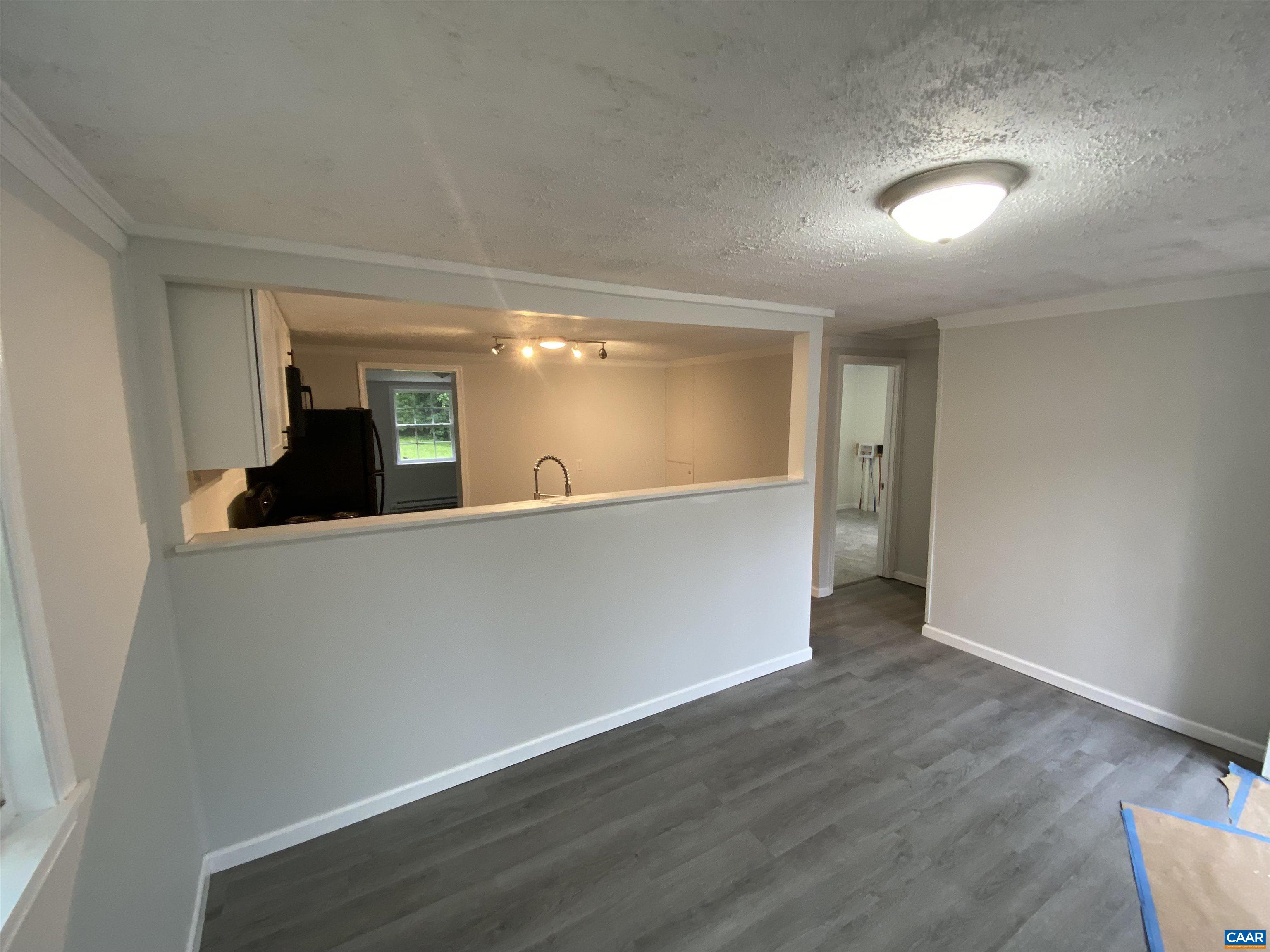 193 Rock Road New Canton, VA 23123 - Photo 4 of 12 wooden floor in an empty room with a mirror