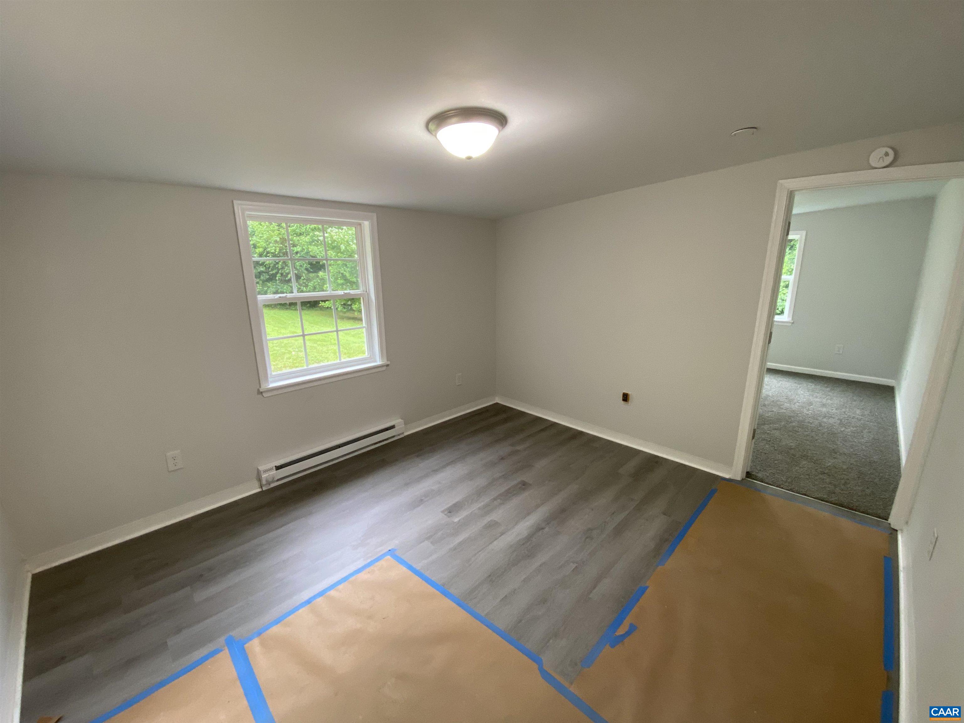 193 Rock Road New Canton, VA 23123 - Photo 5 of 12 an empty room with wooden floor and windows