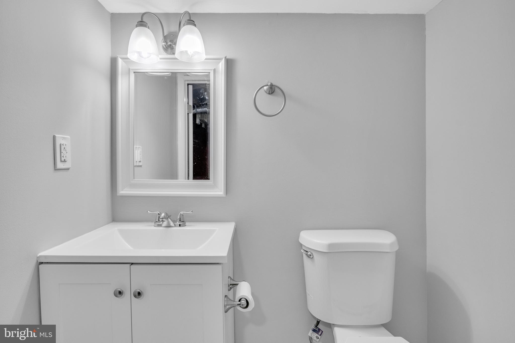 3606 Manchester Avenue Baltimore, MD 21215 - Photo 18 of 21 a bathroom with a toilet sink and mirror