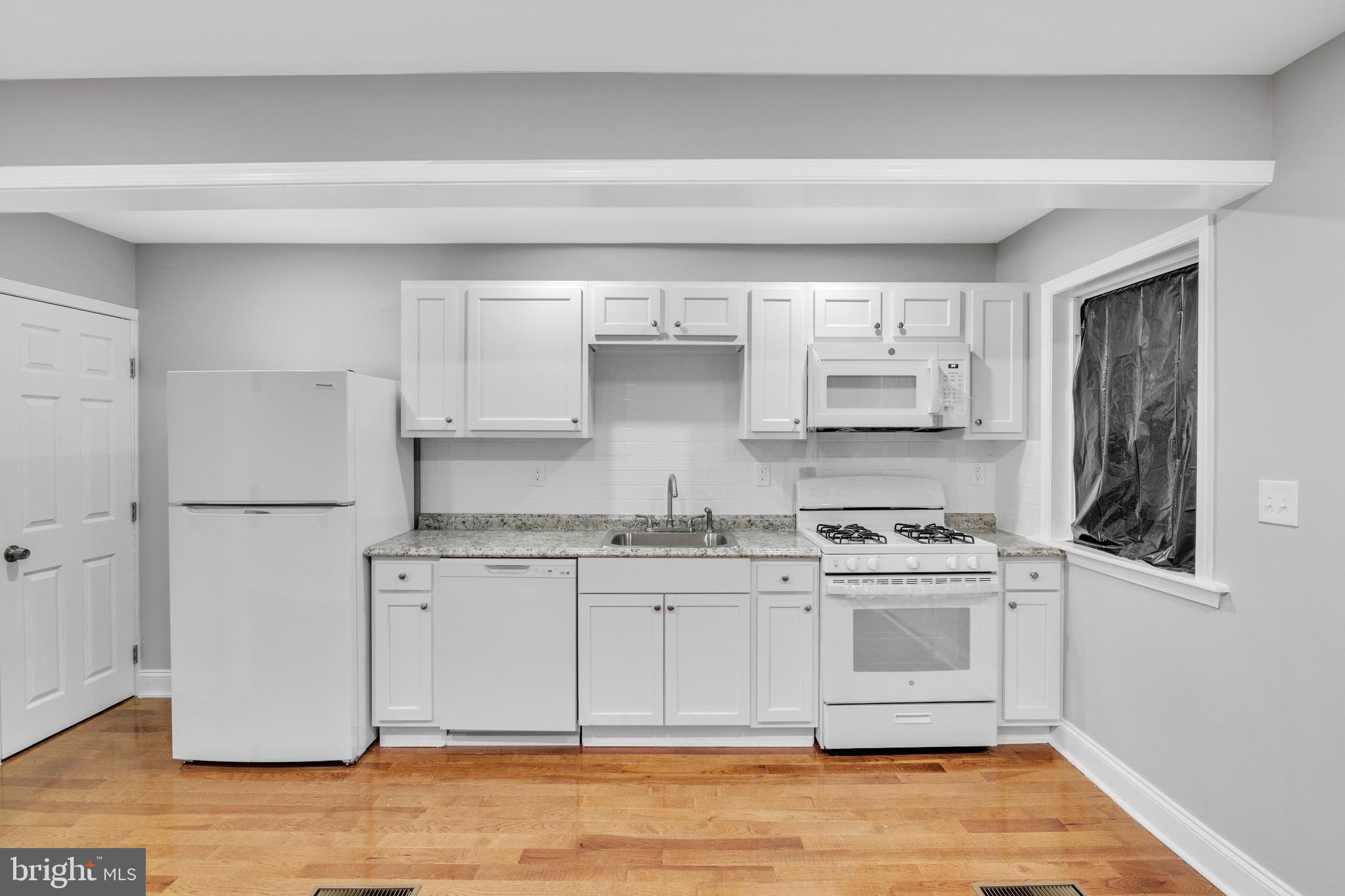3606 Manchester Avenue Baltimore, MD 21215 - Photo 5 of 21 a kitchen with stainless steel appliances granite countertop a stove a sink and a refrigerator
