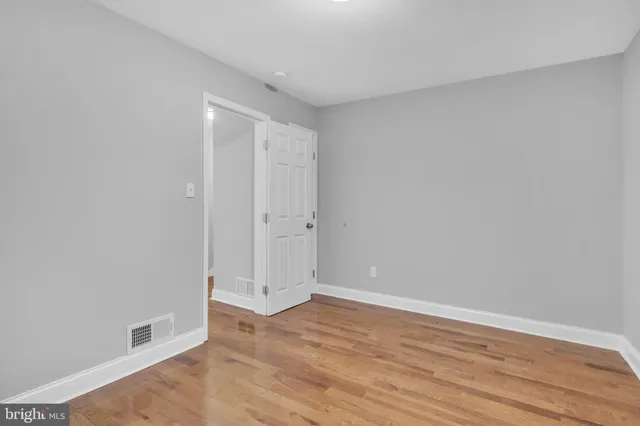 a view of room with window and wooden floor