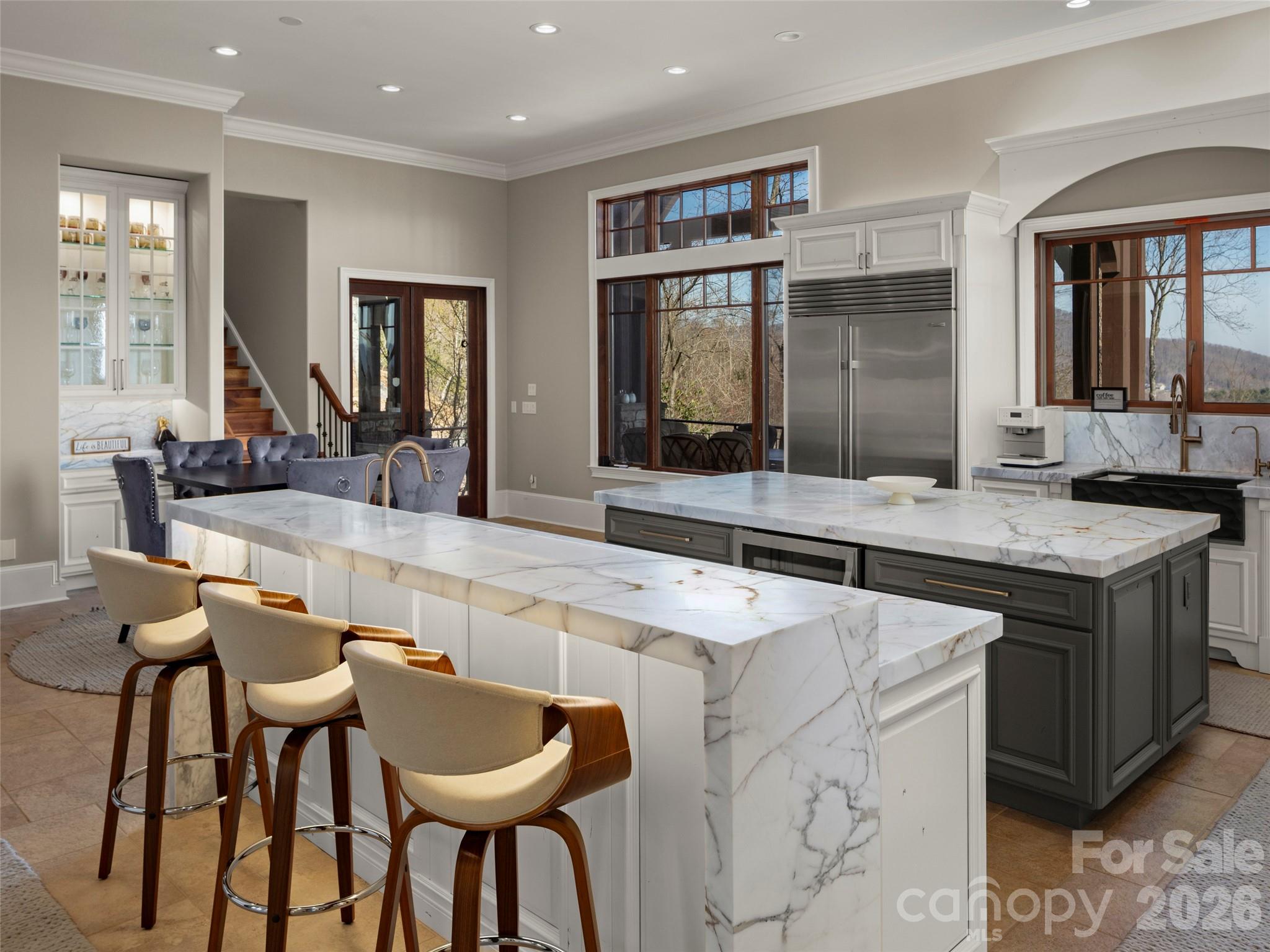 47 Ridge Pine Trail Arden, NC 28704 - Photo 26 of 48 a large kitchen with kitchen island a dining table and chairs