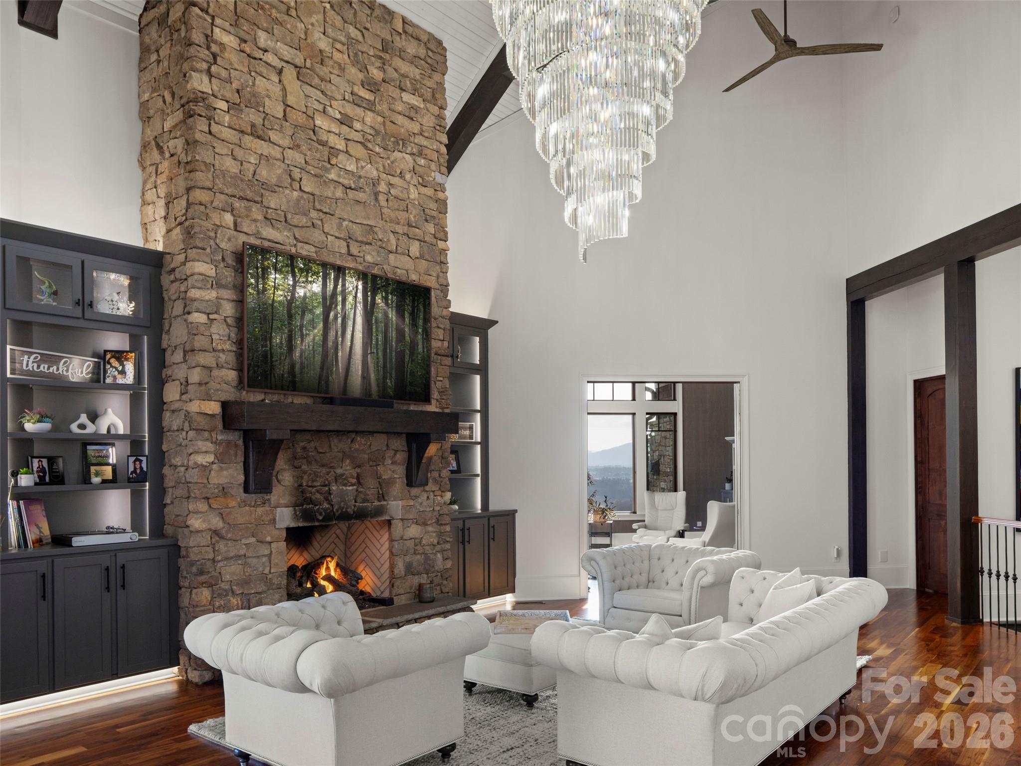 47 Ridge Pine Trail Arden, NC 28704 - Photo 28 of 48 a living room with furniture a fireplace and a chandelier