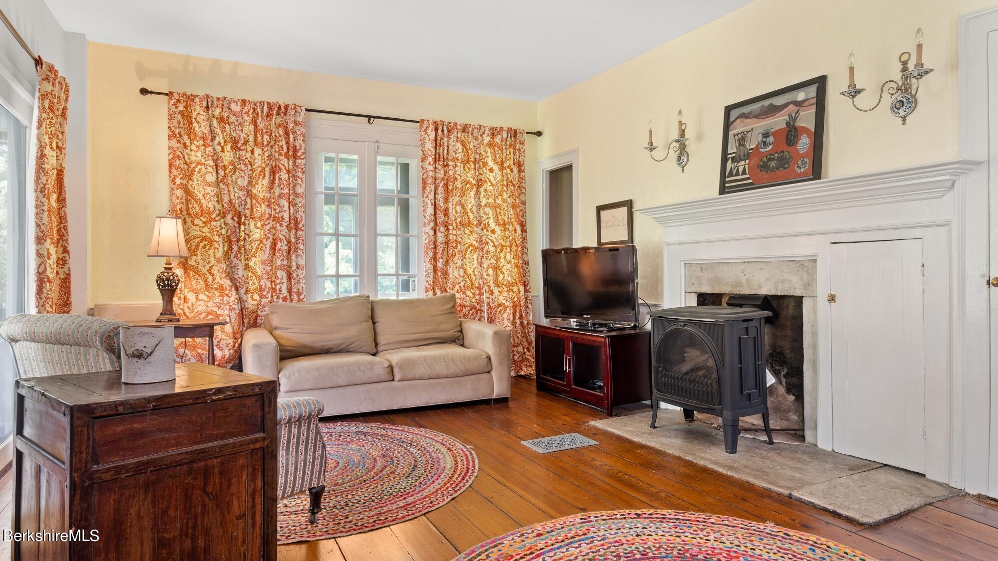 25 Cross Road West Stockbridge, MA 01266 - Photo 15 of 44 a living room with furniture a fireplace and a flat screen tv