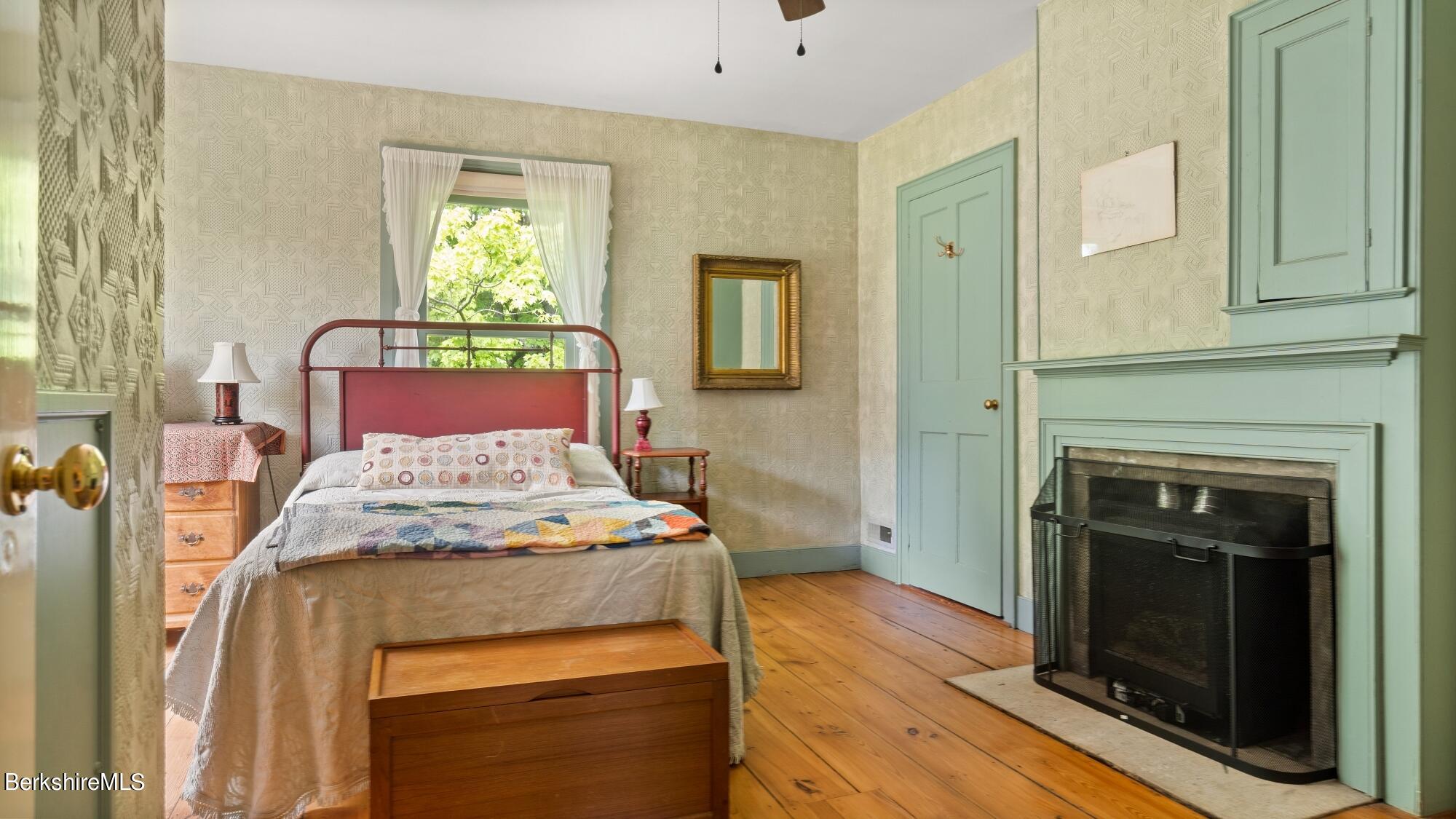 25 Cross Road West Stockbridge, MA 01266 - Photo 28 of 44 a bed sitting in a bedroom next to a window with fireplace