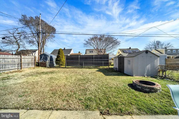 a view of backyard with wooden fence