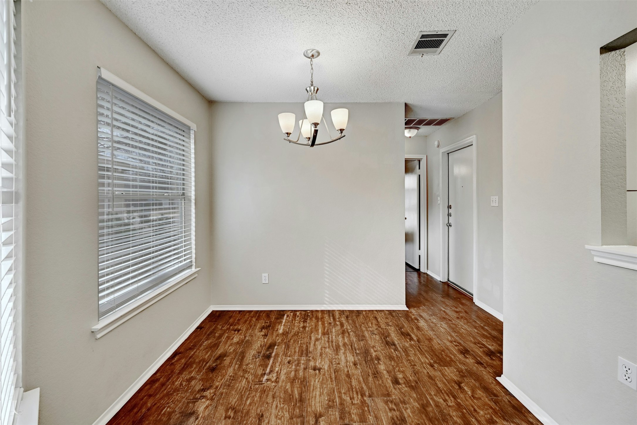 1807 Hollow Tree Boulevard Round Rock, TX 78681 - Photo 12 of 40 wooden floor in an empty room with a window