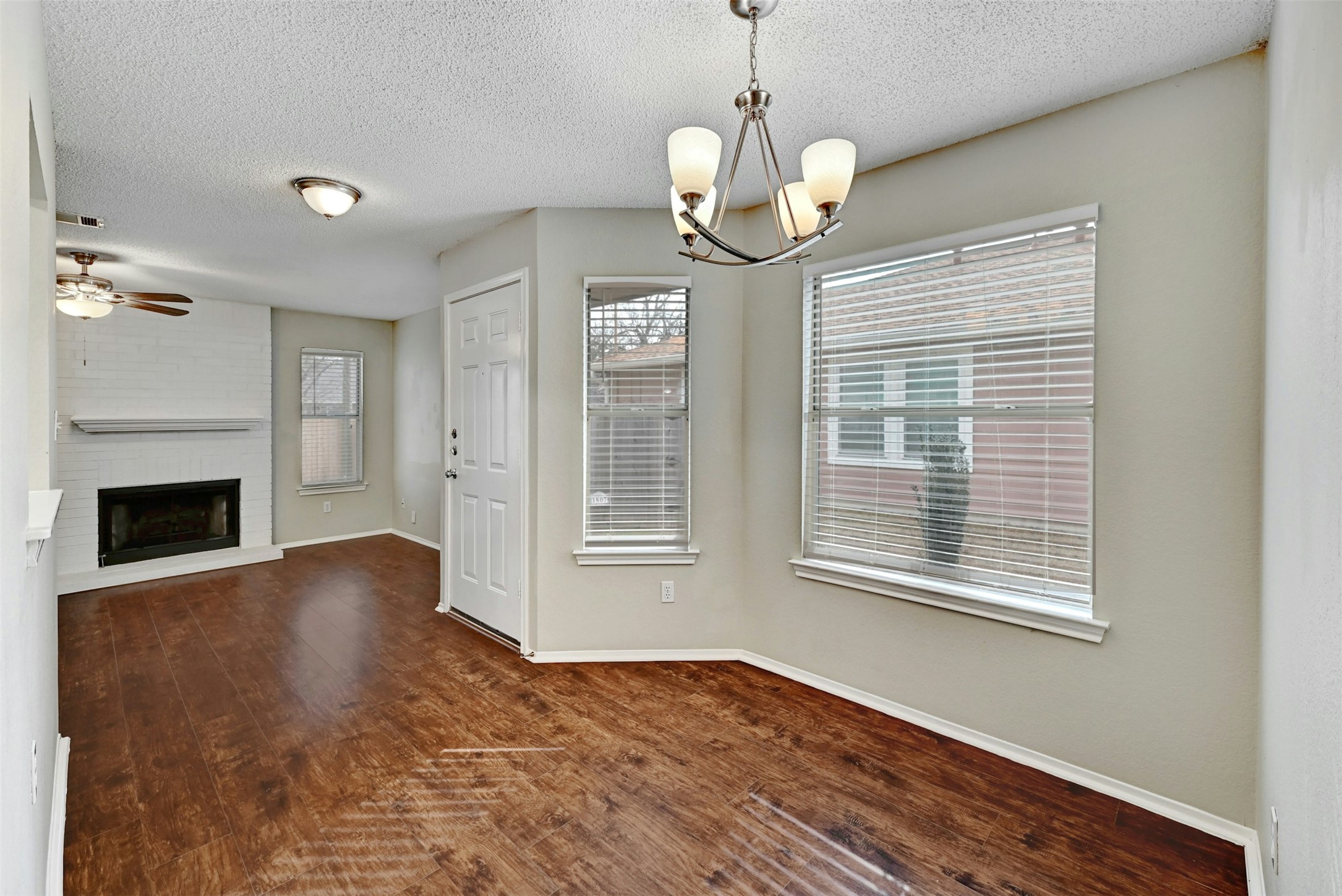 1807 Hollow Tree Boulevard Round Rock, TX 78681 - Photo 14 of 40 a view of an empty room with wooden floor fireplace and a window