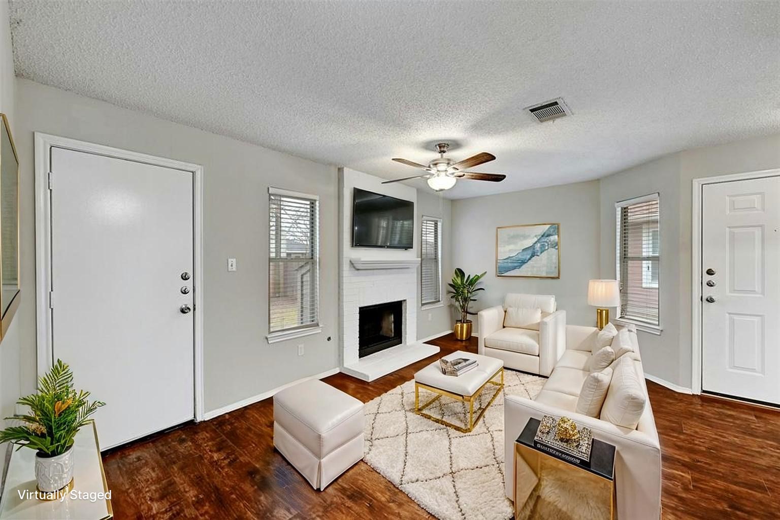 1807 Hollow Tree Boulevard Round Rock, TX 78681 - Photo 2 of 40 a living room with furniture a fireplace and a chandelier