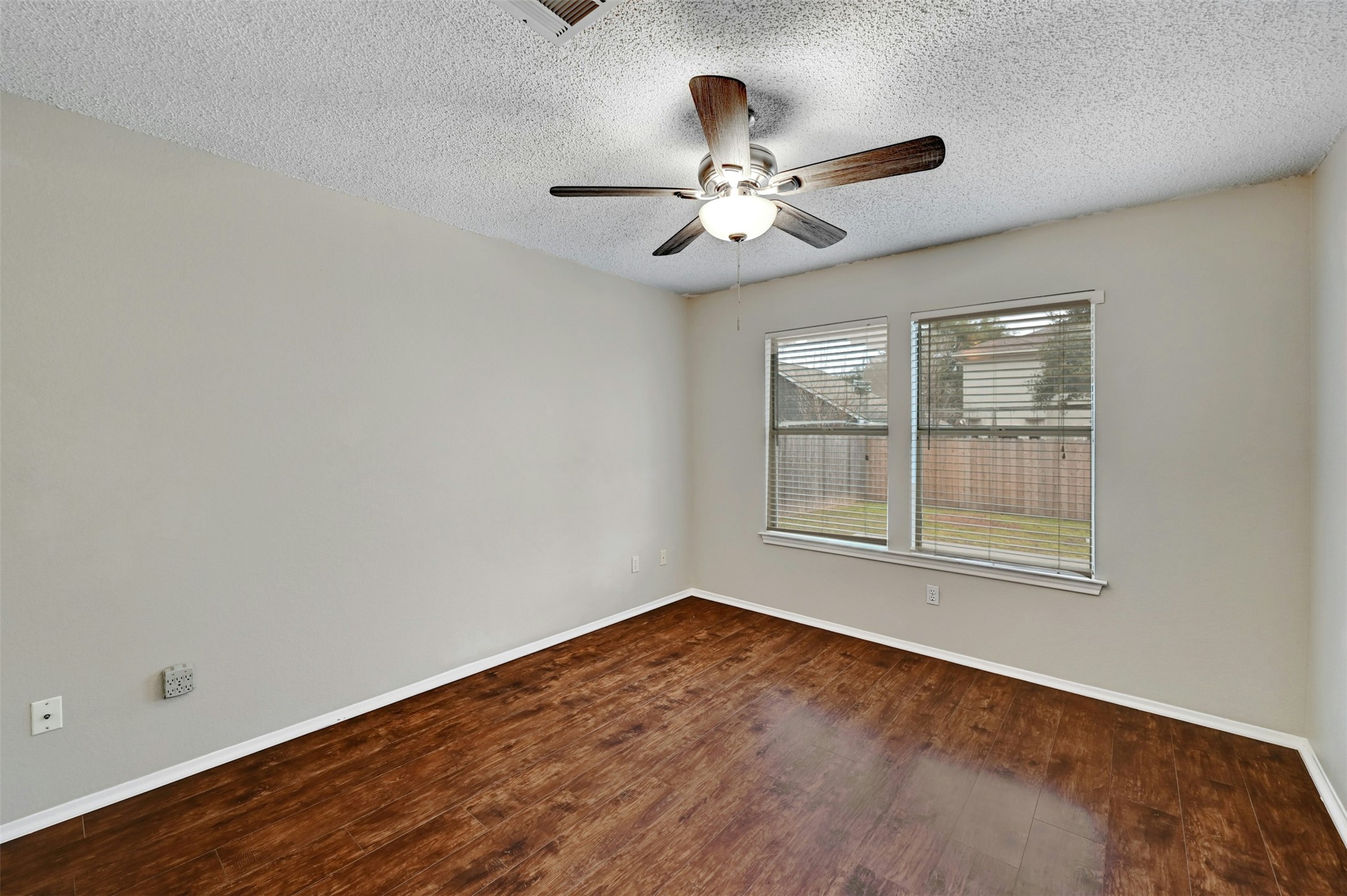 1807 Hollow Tree Boulevard Round Rock, TX 78681 - Photo 21 of 40 a view of an empty room with chandelier fan and wooden floor