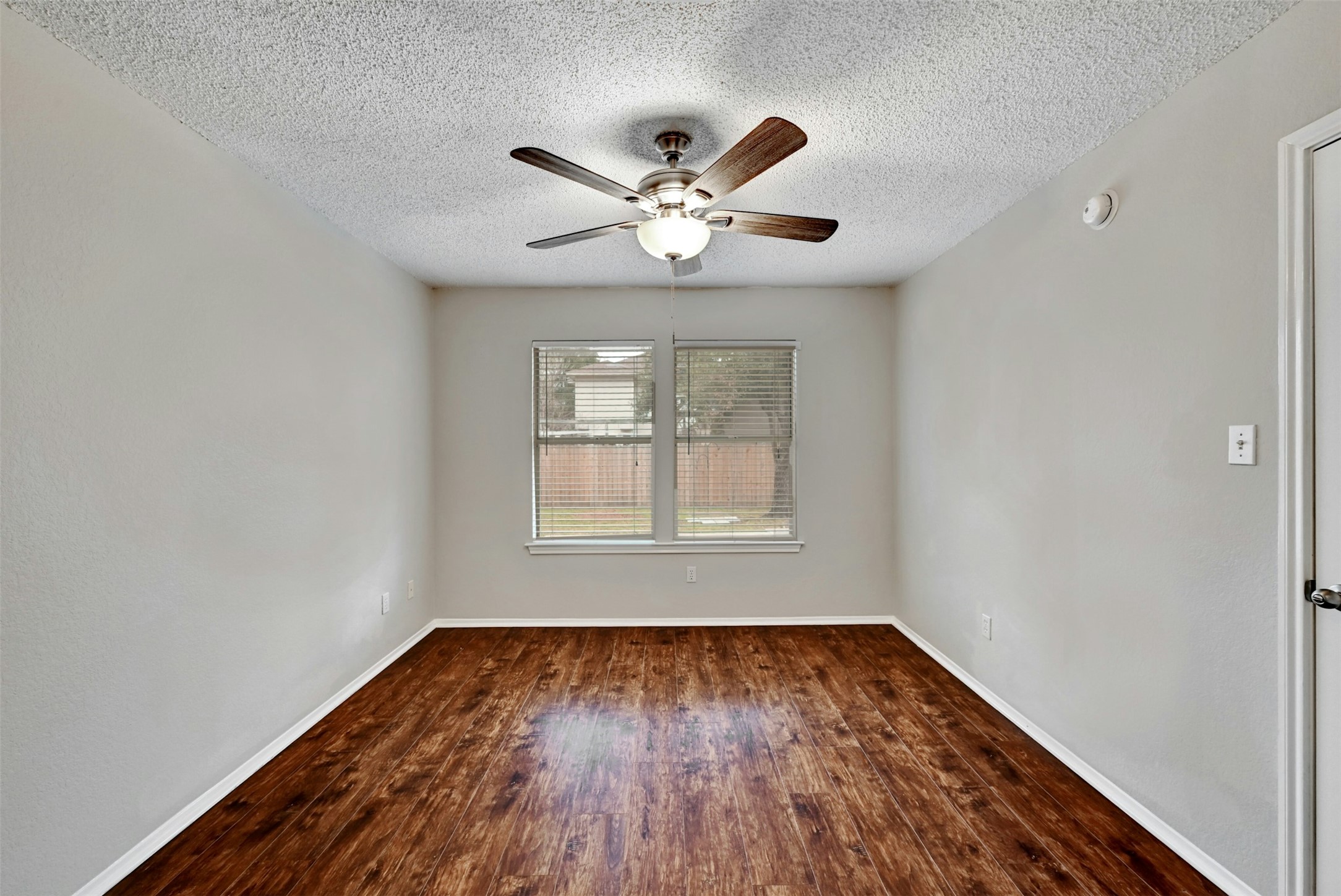 1807 Hollow Tree Boulevard Round Rock, TX 78681 - Photo 22 of 40 an empty room with wooden floor and windows