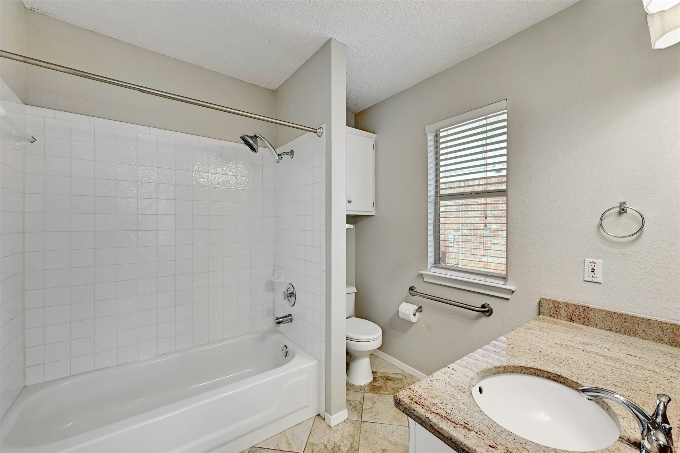 1807 Hollow Tree Boulevard Round Rock, TX 78681 - Photo 25 of 40 a bathroom with a granite countertop toilet a sink and bathtub