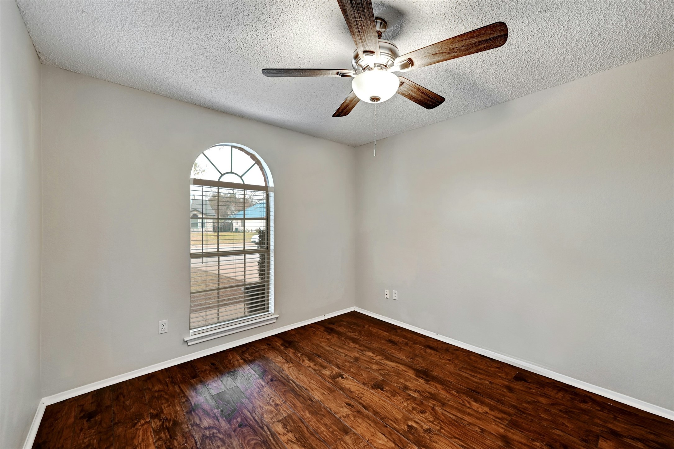 1807 Hollow Tree Boulevard Round Rock, TX 78681 - Photo 28 of 40 an empty room with wooden floor fan and windows