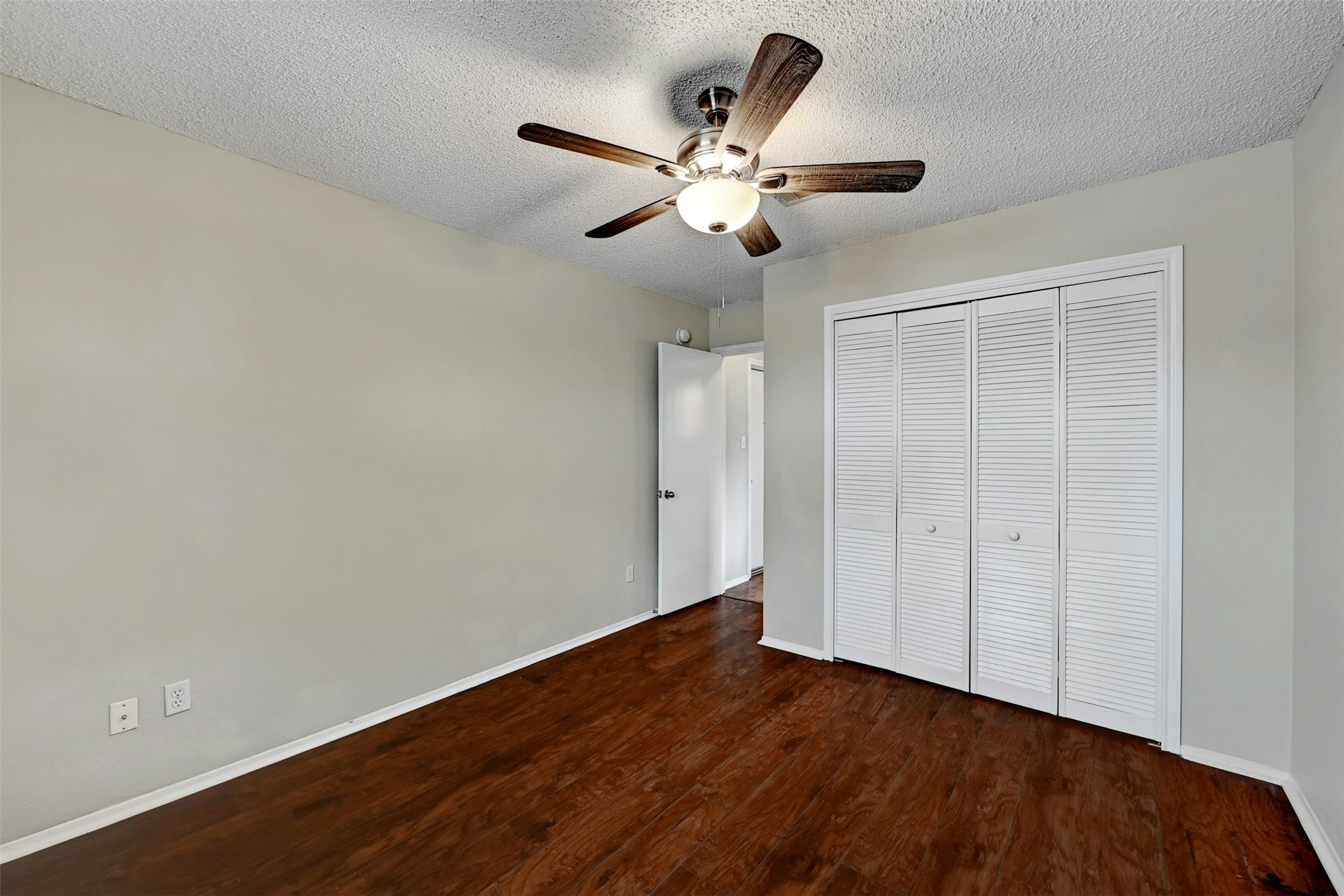 1807 Hollow Tree Boulevard Round Rock, TX 78681 - Photo 29 of 40 an empty room with wooden floor closet and ceiling fan
