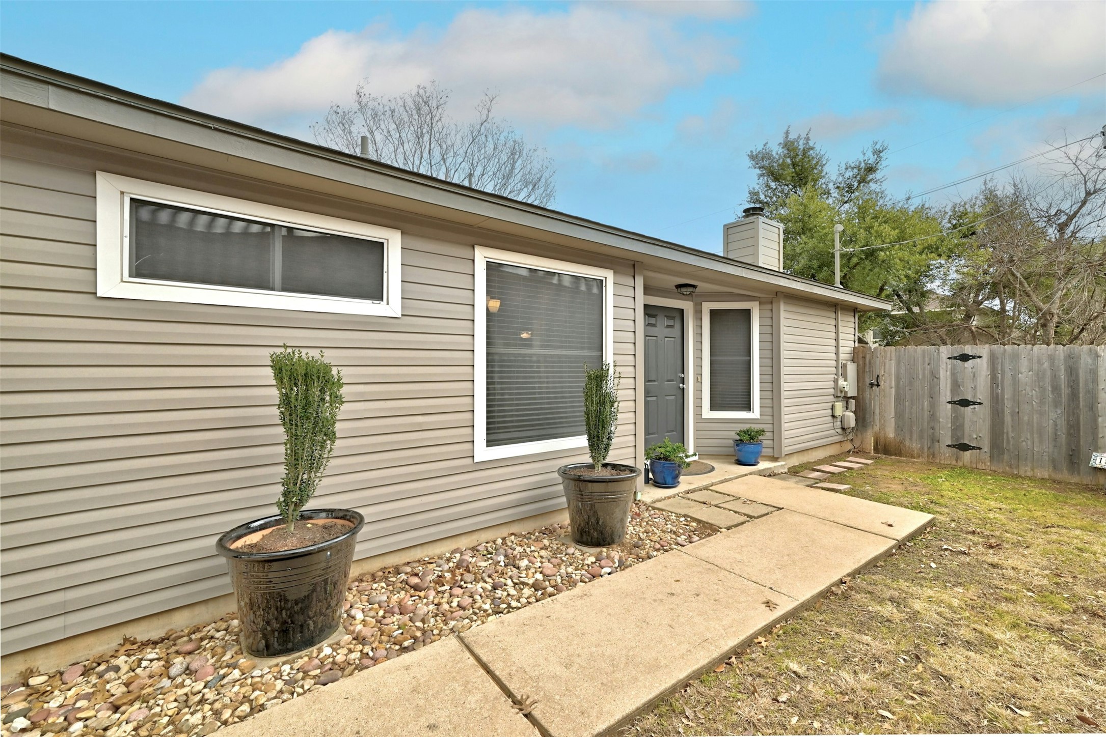1807 Hollow Tree Boulevard Round Rock, TX 78681 - Photo 5 of 40 a view of a backyard with chair and potted plants