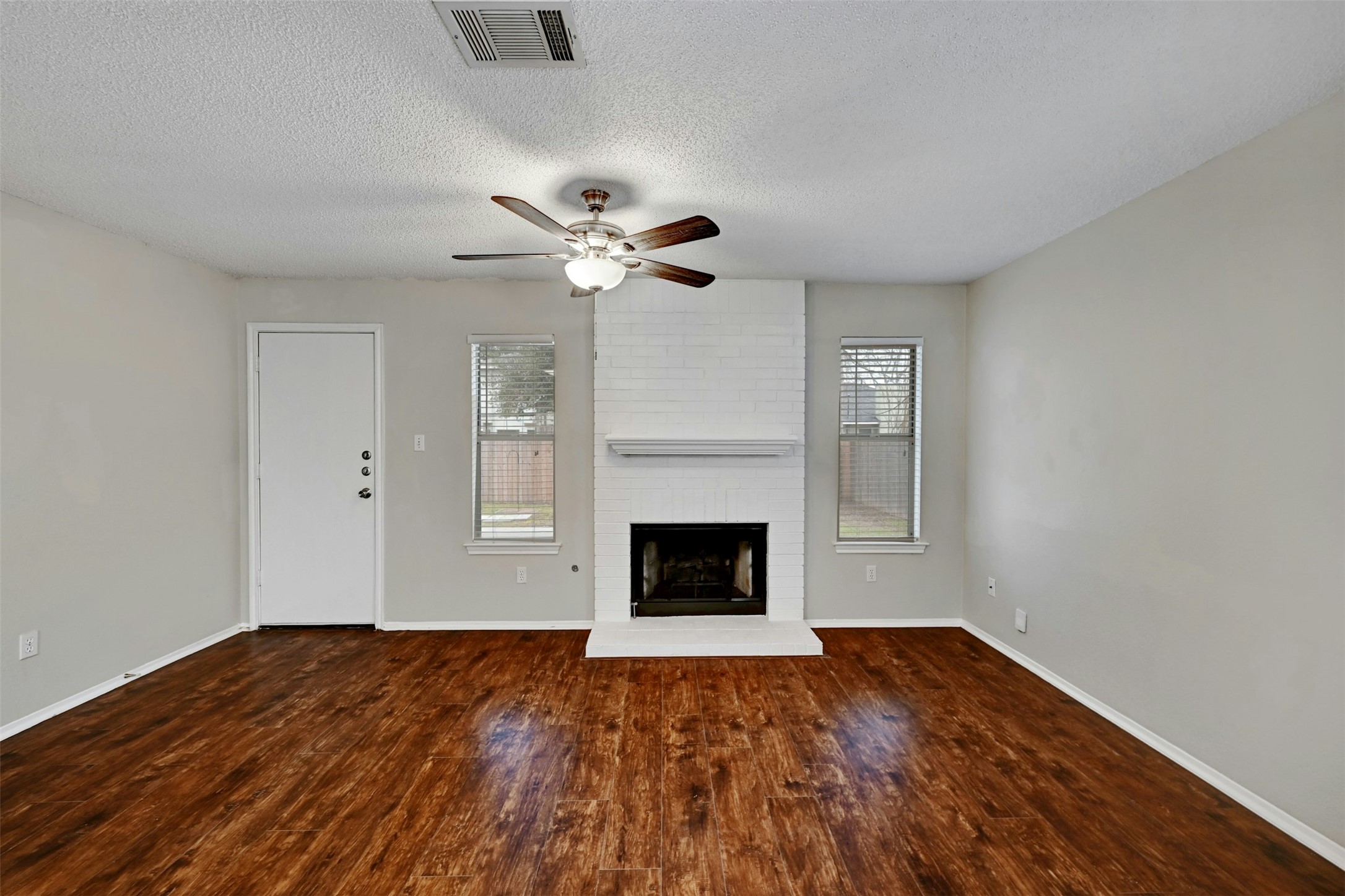 1807 Hollow Tree Boulevard Round Rock, TX 78681 - Photo 7 of 40 a view of an empty room with wooden floor fireplace and a window