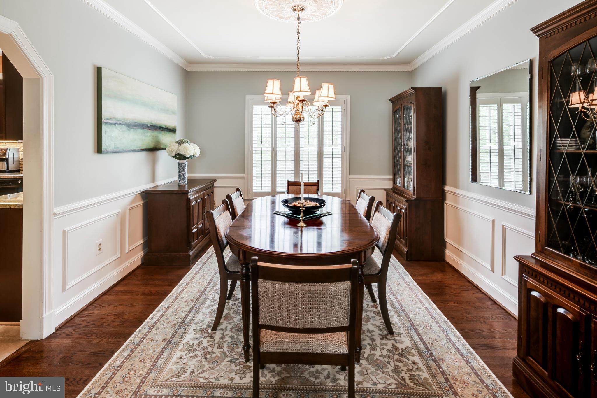 14608 Cutstone Way Silver Spring, MD 20905 - Photo 10 of 30 a dining room with furniture a chandelier and wooden floor