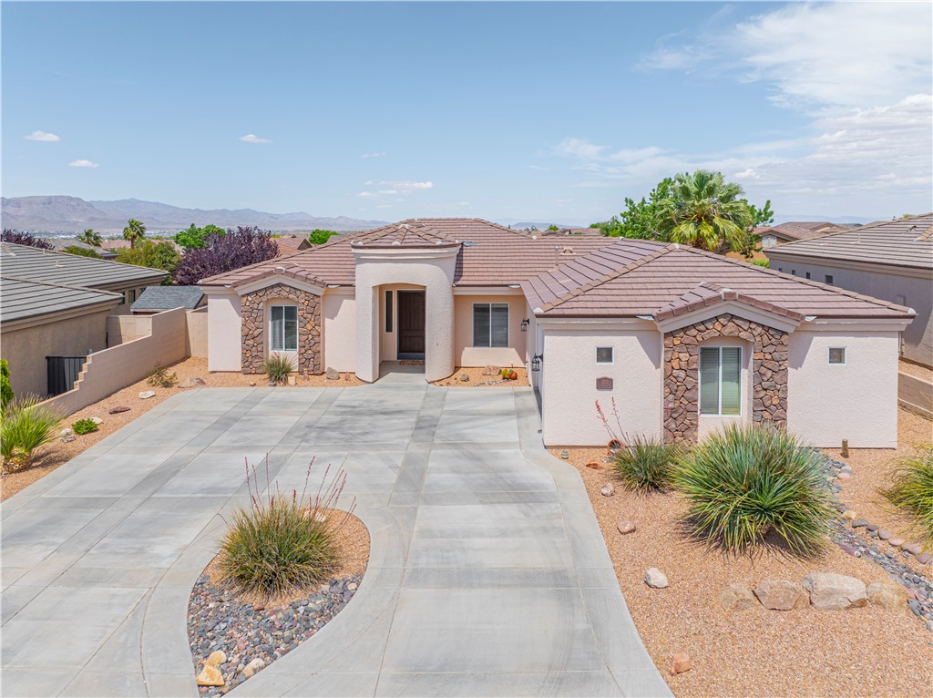 3315 Rainbow Mine Road Kingman, AZ 86401 - Photo 2 of 54 The property features a stucco exterior with natural stone accents and a tiled roof