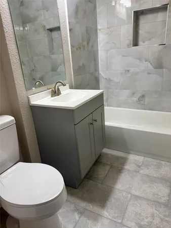 a bathroom with a sink a toilet and bathtub