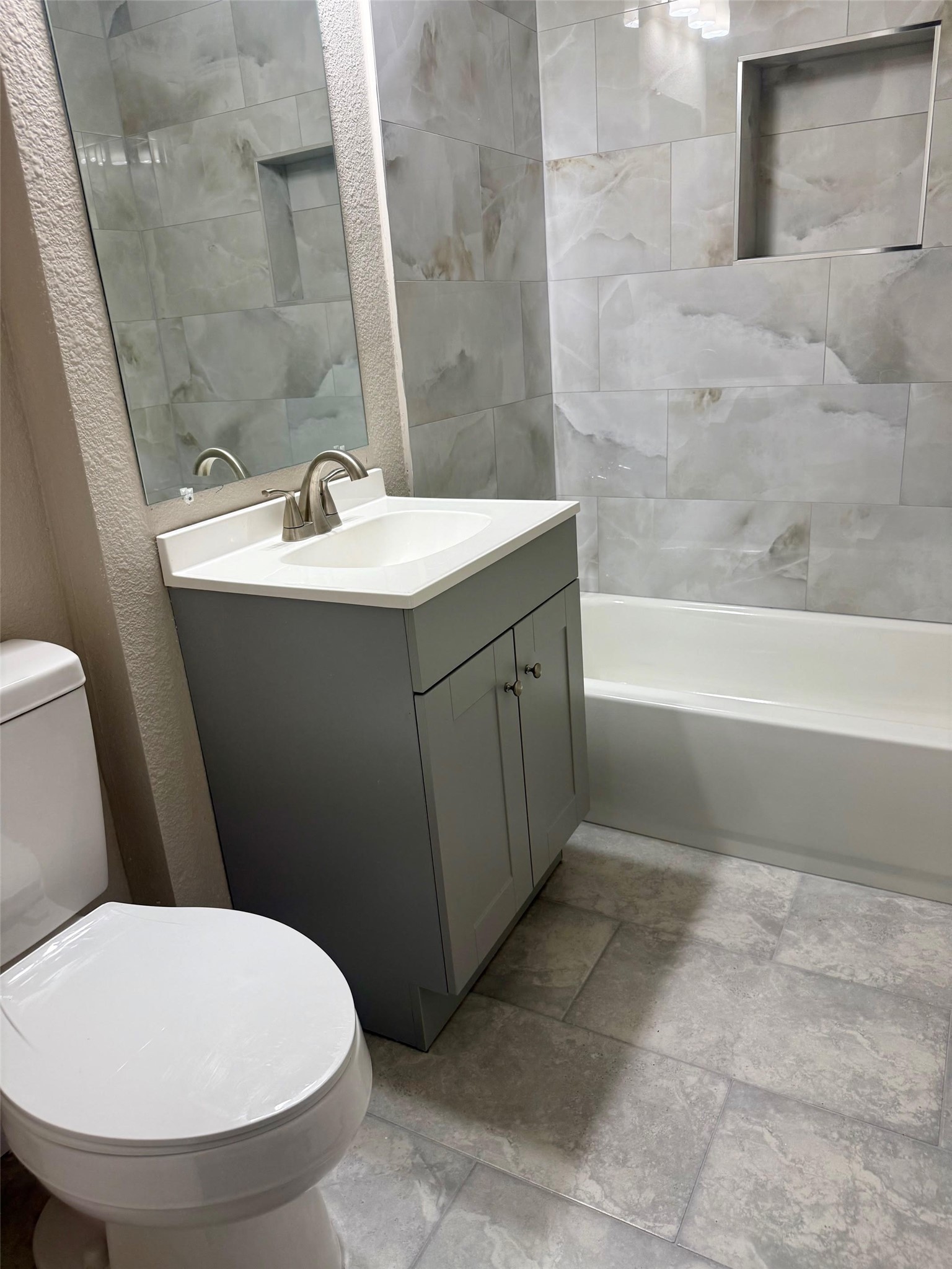 6743 Crestmont Street Houston, TX 77033 - Photo 3 of 11 a bathroom with a sink a toilet and bathtub