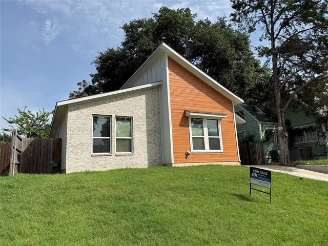 a view of a house with a yard and sitting area