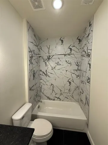 a bathroom with a toilet and a bathtub