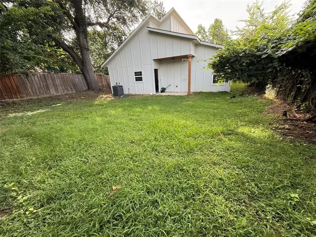 a white house that has a tree in front of it