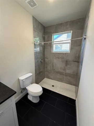 a bathroom with a bathtub and a toilet