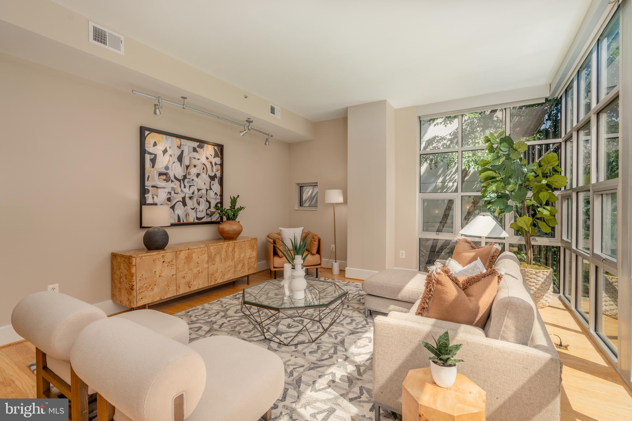2100 11th Street Northwest, Unit 201 Washington, DC 20001 - Photo 13 of 38 a living room with furniture and a large window