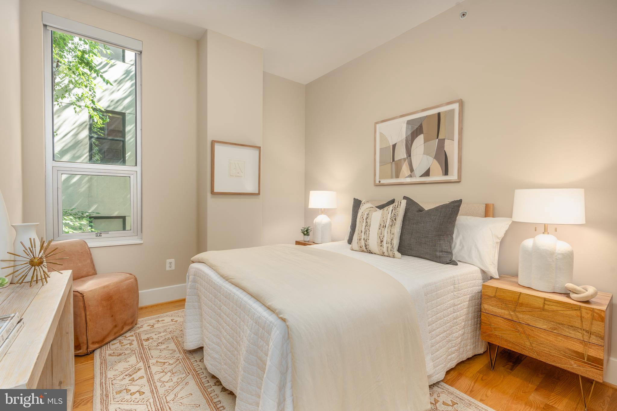 2100 11th Street Northwest, Unit 201 Washington, DC 20001 - Photo 28 of 38 a spacious bedroom with a bed and wooden floor