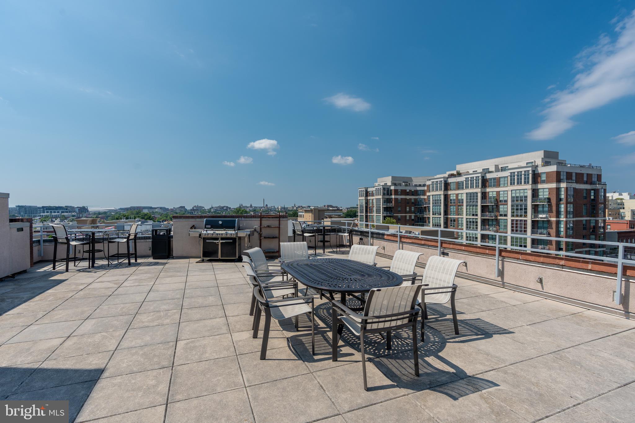 2100 11th Street Northwest, Unit 201 Washington, DC 20001 - Photo 35 of 38 a patio with a table and chairs and potted plants