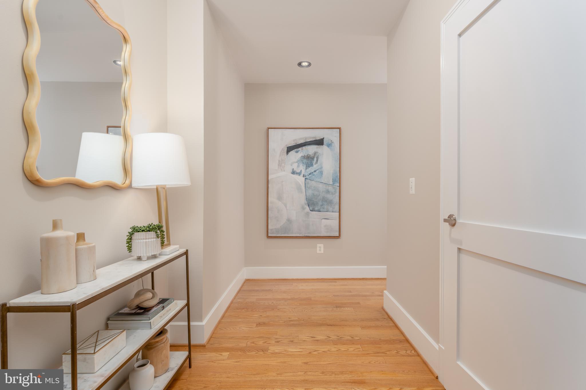 2100 11th Street Northwest, Unit 201 Washington, DC 20001 - Photo 7 of 38 a hallway with table and flowerpot