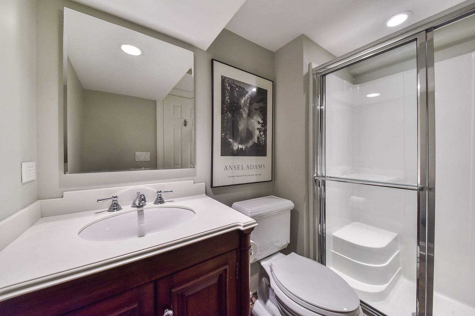 1211 Sunset Road Geneva, IL 60134 - Photo 51 of 65 a bathroom with a sink a toilet a mirror and shower