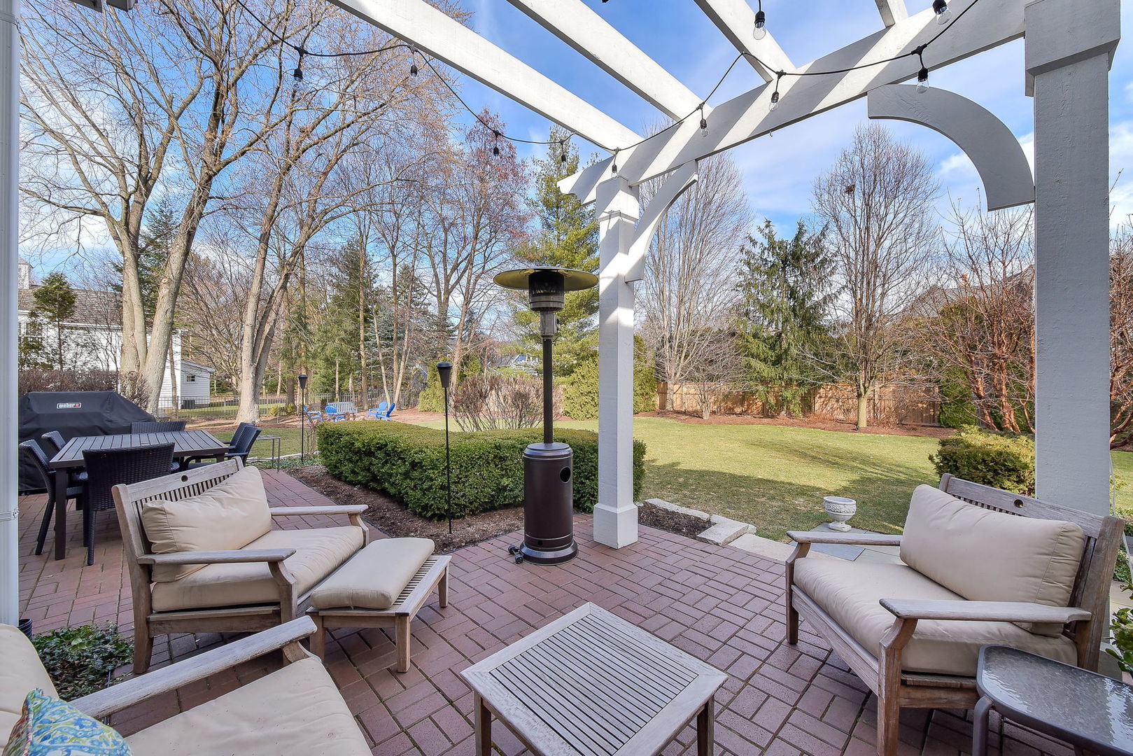 1211 Sunset Road Geneva, IL 60134 - Photo 52 of 65 a view of a patio with couches table and chairs with wooden floor and fence