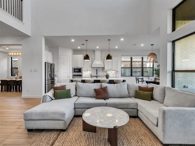 a view of a livingroom with wooden floor and stairs