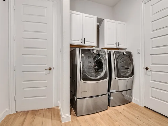 a bedroom with a large bed and a flat tv screen